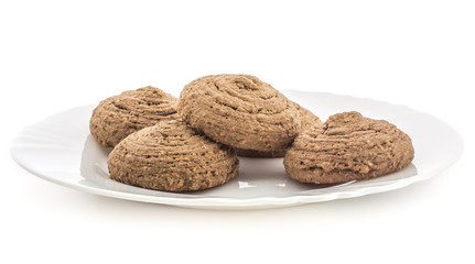 Cocoa oat cookies on a porcelain plate isolated on white background five drop shape brown crispy biscuits.
