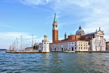 Fototapeta na wymiar Daylight view from boat to San Giorgio Maggiore church with ornamented facade