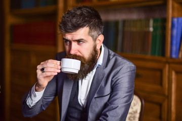 Mature hipster man holding a cup