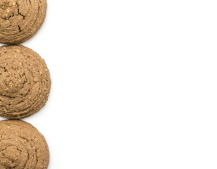 Three cocoa oat cookies in row top view isolated on white background drop shape brown crispy biscuits.