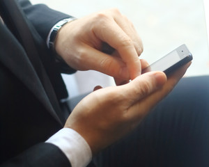 closeup.businessman typing SMS on the smartphone