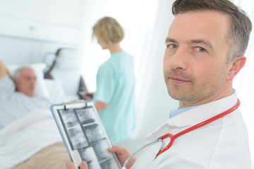 hospital doctor holding patients x-ray film