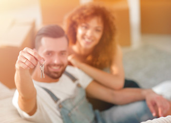 Young couple with a key to a new apartment.