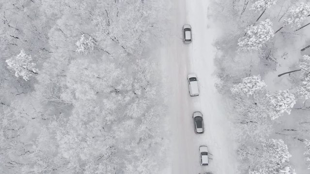 Cars in the winter on an iced road, aerial view