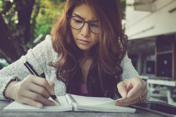 young woman concentrate reading book. girl learning writing homework. education assessment concept....