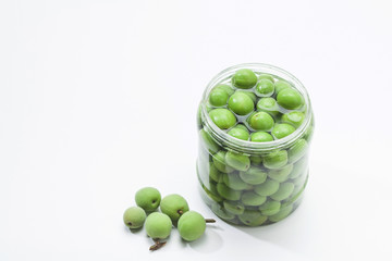 Canned Green plum in a glass jar