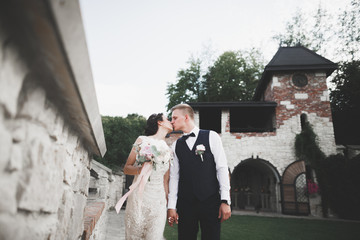 Happy wedding couple walking in a botanical park