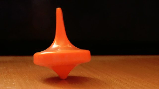The video shows Orange spinning top spinning on the table
