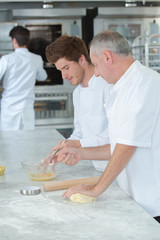 chef giving lesson to the intern