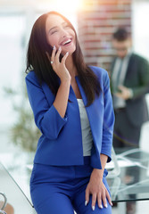 Attractive brunette businesswoman talking on mobile phone