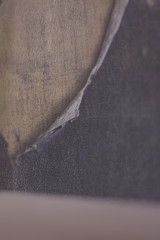 Vintage antique shabby chic background of aged paper and textile in blue and beige. Torned corner. Shallow depth of field.
