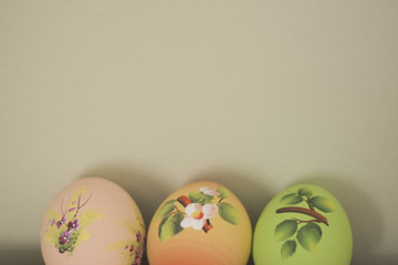 Easter egg hand painted craft decorated. Lying in egg carton. on rustic wood.  Shallow depth of field. Colourful.