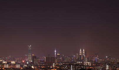 Plakat Night view of Kuala Lumpur city skyline with dusty and thick fog.