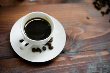 Hot coffee in white cup on wood background