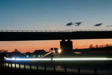 Traffic autobahn bridge at sunset