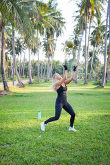 athlete at tropical park. woman fitness sunrise jogging workout wellness concept.