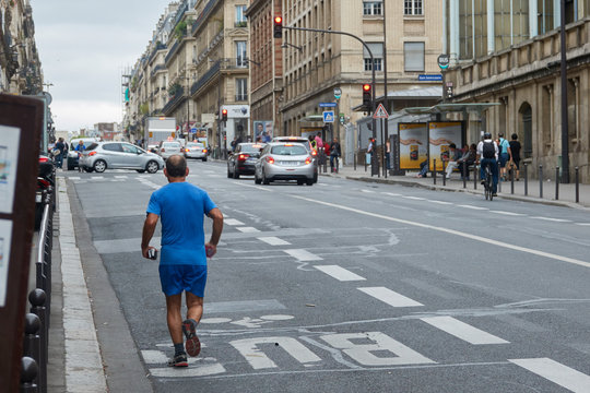 A man runs around the streets of Paris in the morning