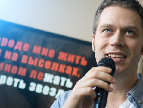 Man singing karaoke at home. Close-up view.