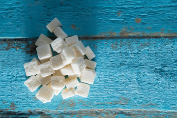 pressed sugar cubes sugar refined on a textured wooden surface and on a white background isolate