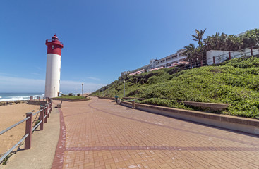 Fototapeta na wymiar Lighthouse on Paved Beachfront Promenade at Umhlanga