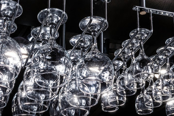 Glass goblets suspended above the bar, glare on the glass