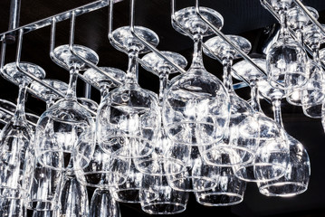 Glass goblets suspended above the bar, glare on the glass