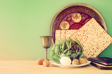 Fototapeta na wymiar Pesah celebration concept (jewish Passover holiday). Traditional book with text in hebrew: Passover Haggadah (Passover Tale).