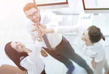 successful business team giving each other a high five .