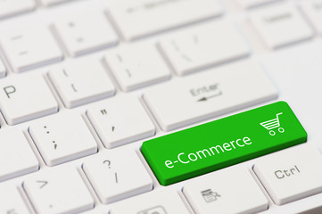 A green key with eCommerce text on white laptop keyboard