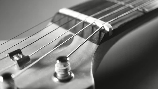 Head of electric guitar close up black and white