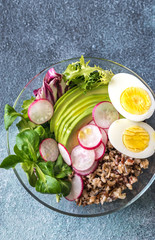 Bowl of wild rice with avocado, egg and lettuce