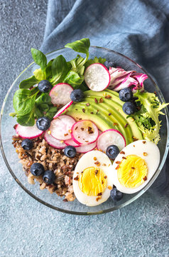Bowl of wild rice with avocado, egg and lettuce
