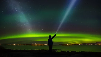 Peel and stick wallpaper Northern Lights Woman standing with headlamp in the tide looking at nightsky, milky way and aurora.