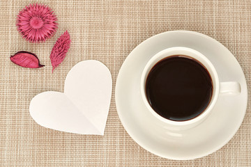 White cup and saucer with a braun background 