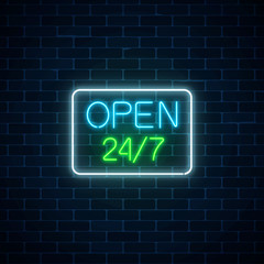 Glowing neon sign of open 24 hours 7 days a week store in geometric shape on a brick wall background.