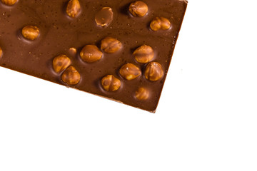 Dark chocolate with hazelnuts isolated on a white background