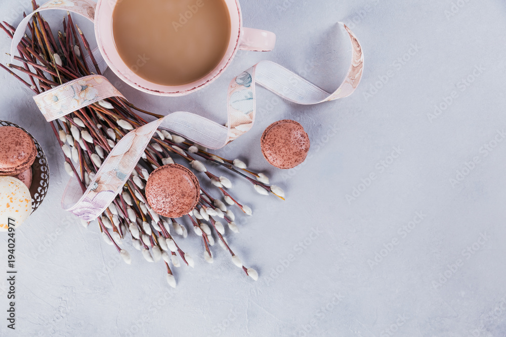 Wall mural Pink coffee mug with sweet pastel french macaroons and pussy willow