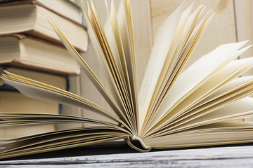 Open book, hardback books on wooden table. Back to school. Copy space