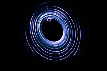 Painting with light coming from the diode. A spiral outline drawn by a flashlight suspended on a...