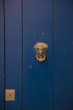 blue door with door knocker in Sitges, Spain