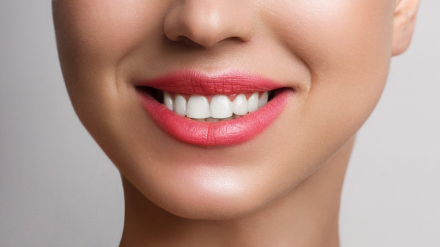 Beautiful smile with whitening teeth. Dental photo. Macro closeup of perfect female mouth, lips care. Stomatology, cosmetology