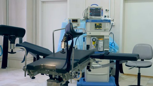 Empty gynecological examination chair in a hospital room