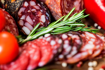 Three sorts of salami with tomatoes and peppercorn