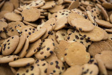 Close up of rows of oatmeal raisin cookies sitting on wax paper on table top