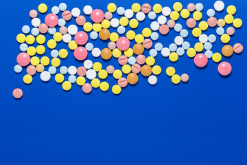 Medical tablets. On a blue background. View from above . The concept of medicine