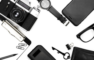 black clock, black pencil, black notepad, camera, black glasses, key, wallet on white background