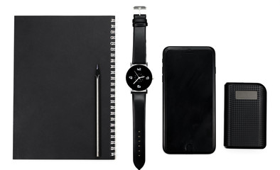 black clock, black pencil, notebook, phone and a power station on a white background