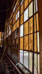 Broken windows in abandoned warehouse industrial space