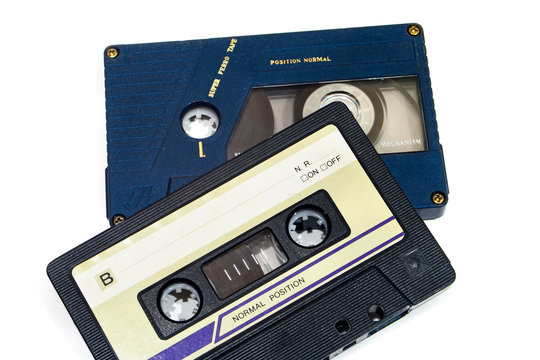 Old audio cassette on white background.