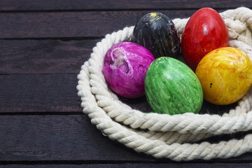Easter holiday concept. Painted eggs in rope. Horizontal view.